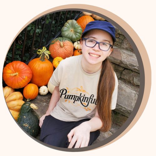 Pumpkin delivery artist on the spectrum holding pumpkins on a porch in Forsyth County